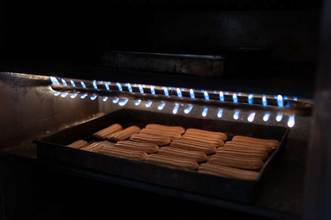Trays of khabeez baking over an open flame.